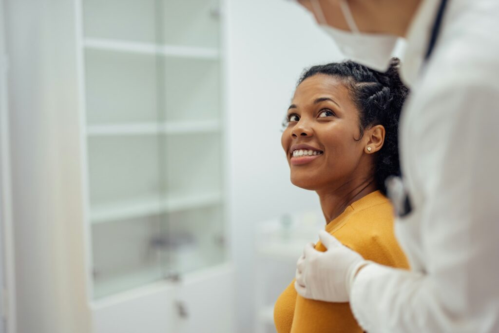 Smiling woman on a medical exam.